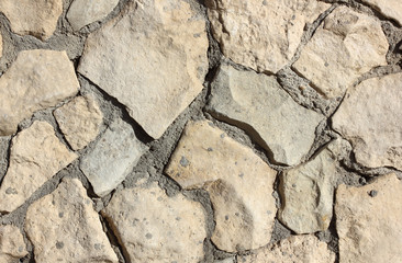 old stone masonry with cement mortar abstract texture background