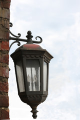 Fototapeta na wymiar Old Lamp Hanging On Brick Wall