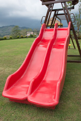 Red Slider  (kids playground equipment)at the kids on the lawn.