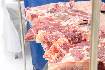 Frozen pig meat on the counter of street fair site winter