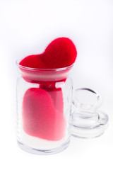 Red plush hearts in a jar, isolated on white. Valentine Day. Love.