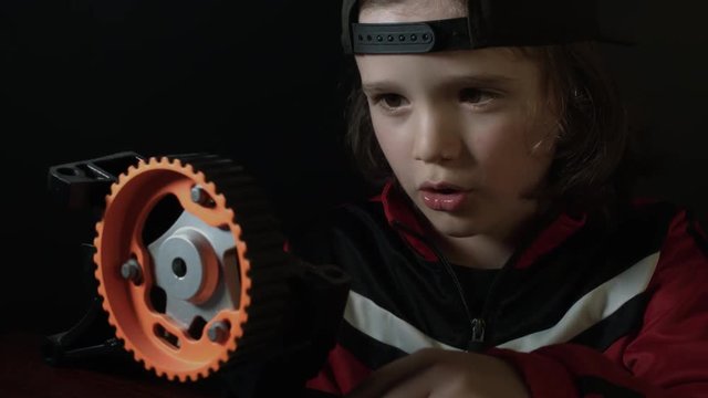 4k shot of a cute child working in laboratory-Exploring a Gear spinning