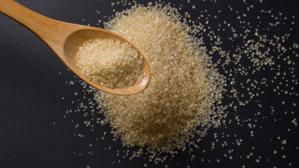 Close up brown sugar in wooden spoon