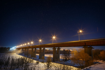Highway bridge with a starry sky, lit by lanterns. Night landsca