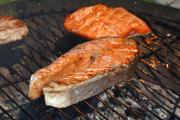 Salmon fish steak barbecue grill cooking close up