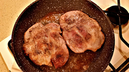Pork steaks in a pan