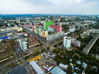 Bright colored house stands in the middle of the gray