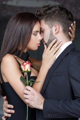 Young man give rose to lover indoor first kiss