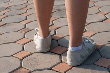 Leg of female walk on ground,close up of shoe,soft focus.