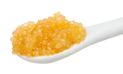 yellow caviar of pike fish in ceramic spoon