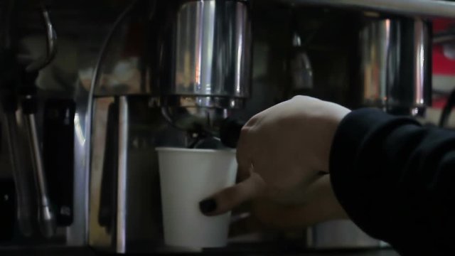 Barista preparing cups of coffee in a cafe.