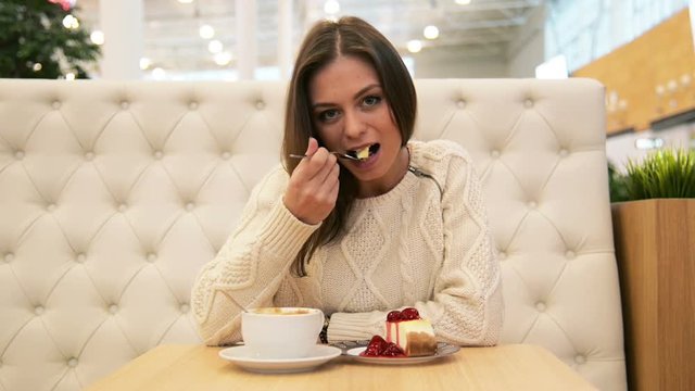 Happy woman eating tasty desser