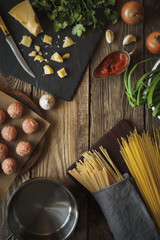 Ingredients for cooking spaghetti, meatballs with cheese and fresh herbs