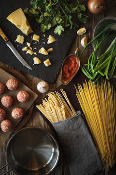 Ingredients for cooking spaghetti, meatballs with cheese and fresh herbs