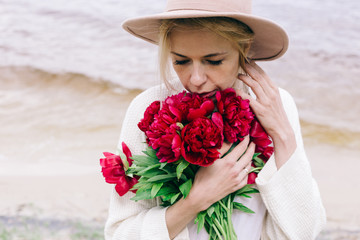 Portrait of girl with peonies in hand, a romantic portrait by th