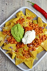 Nachos with avocado dip and beans