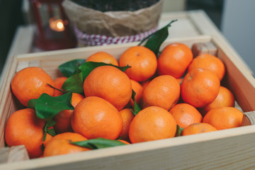 Wooden box of fresh mandarin fruits
