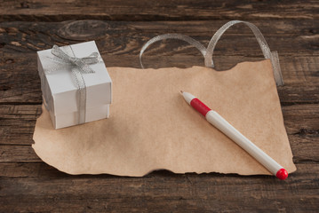 Letter and box on wooden table for Valentines day