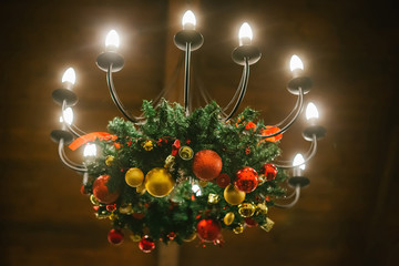 chandelier decorated with a Christmas wreath