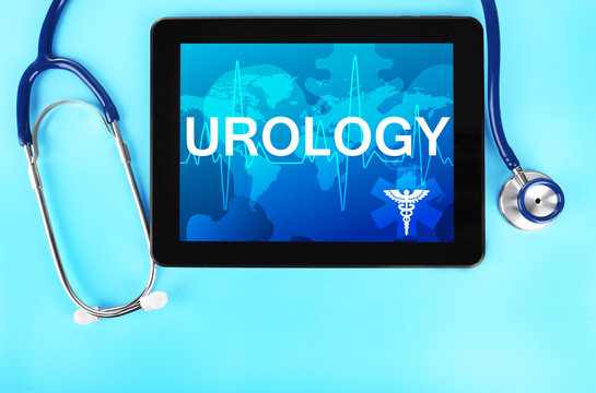 Tablet and stethoscope on blue background. Word UROLOGY on screen. Health care concept.