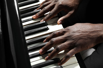 Afro American man hands playing piano © Africa Studio