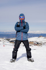 Fototapeta na wymiar man doing victory sign after peak summit trekking achievement in snow mountain on winter landscape