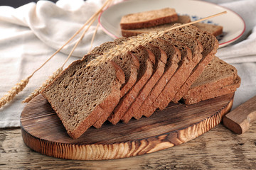 Sliced rye bread on wooden table closeup