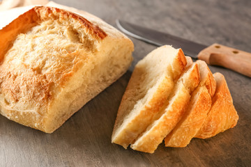 Sliced fresh bread on black table closeup