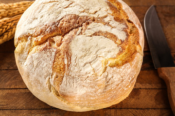 Fresh bread on wooden table closeup