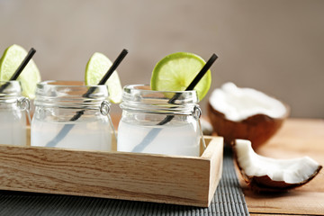 Set of mason jars with coconut water decorated with lime