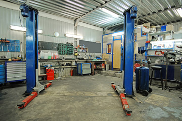 Empty workshop with a lift in a car repair station