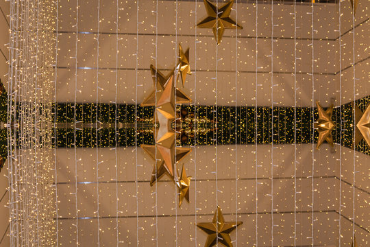 Weihnachtshintergrund mit Lichterkette und golden Sternen.