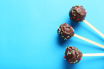 Chocolate cake pops on blue background