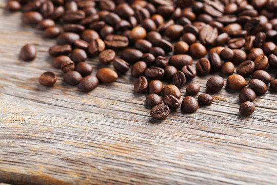 Roasted coffee beans on a grey wooden table
