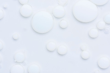 Abstract background with white paint drops in liquid