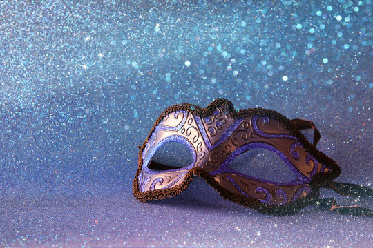 elegant venetian mask on blue glitter background
