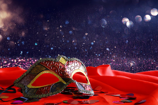 elegant venetian mask on red silk background