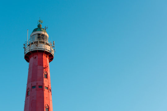 Vintage lighthouse over blue sky background and copy space