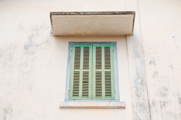 Fototapeta na wymiar Green retro window. Old architectural element. Vibrant colors.