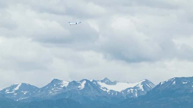 Airliner Flying Over the Snow Capped Martial Mountains in Argentina South America After Taking Off from Ushuaia Malvinas Argentinas International Airport on a Sunny Summers Day