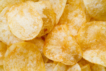 Close up potato chips on wood top view background.