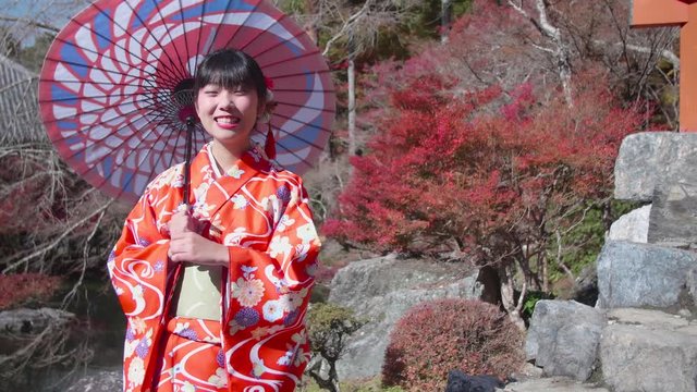 Japanese Kimono women with paracel in Japanese garden 