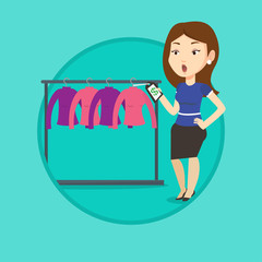 Woman shocked by price tag in clothing store.