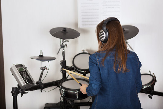 Woman drummer practicing  at home