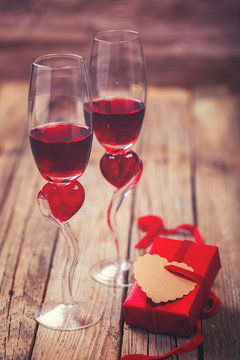 Red Wine and two Glasses in the shape of a Heart.Holiday Valentines Day Box of Gift.Toned image.Vintage style.selective focus.