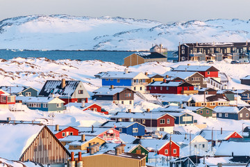Fototapeta premium Nuuk city covered in snow with sea and mountains in the backgrou