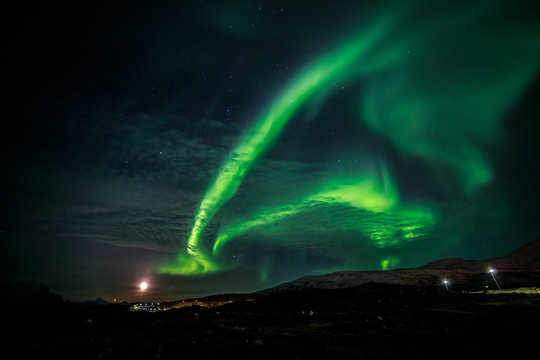 Northern lights and the rising Moon nearby nuuk city, Greenland