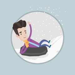 Man sledding on snow rubber tube in the mountains.