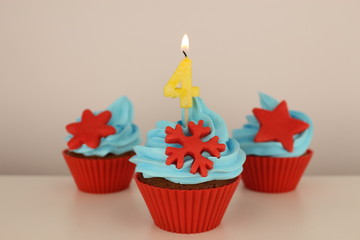 number 4 candle on red cupcake