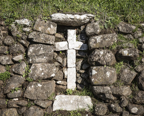 a Stone made cross on a rural stone made wall